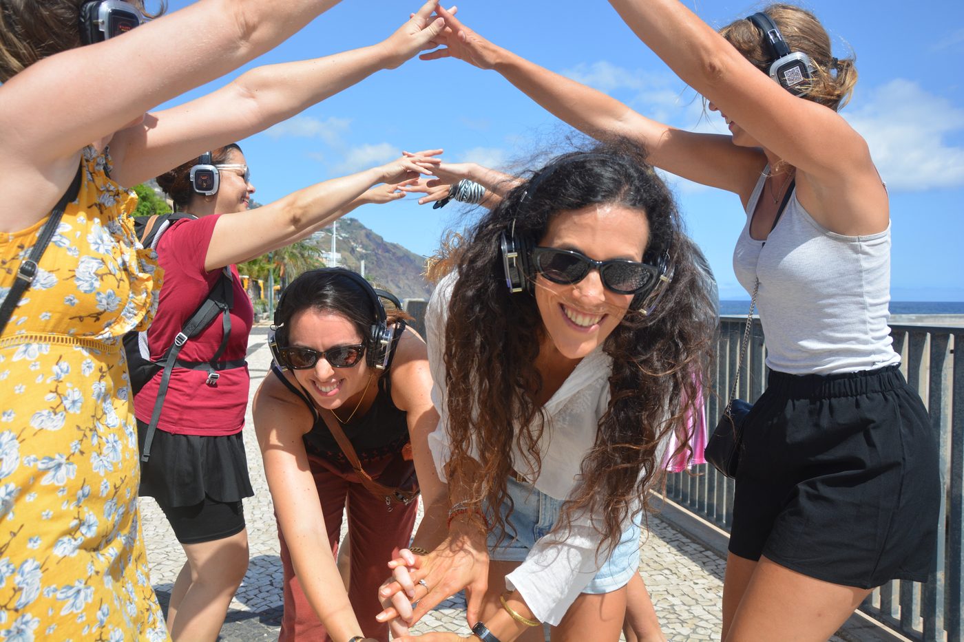 A group of guests on the tour, arms raised together for a photo