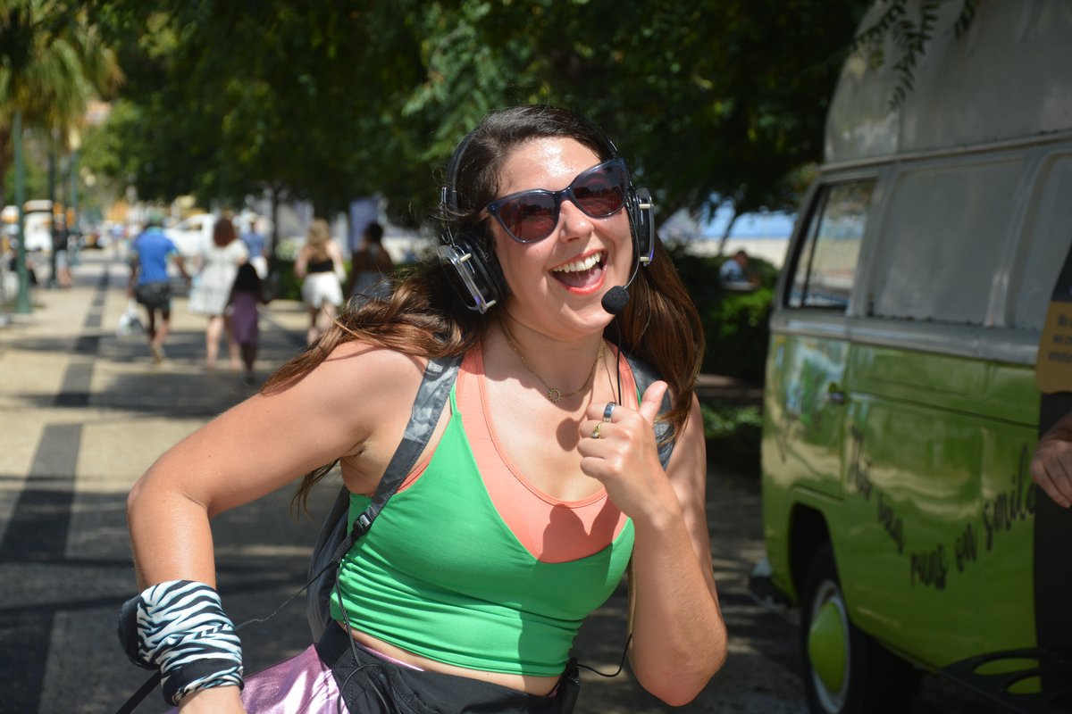 Leila, your Silent Disco Walking Tour guide, waving and smiling in Funchal