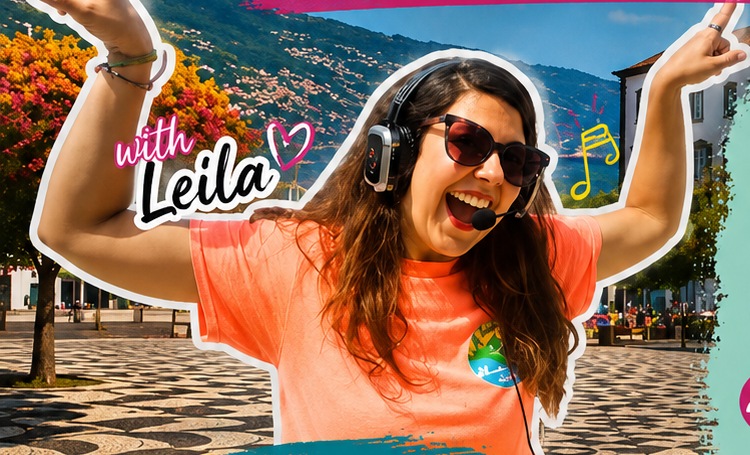 Leila jumping with headphones on, mid-tour in Funchal